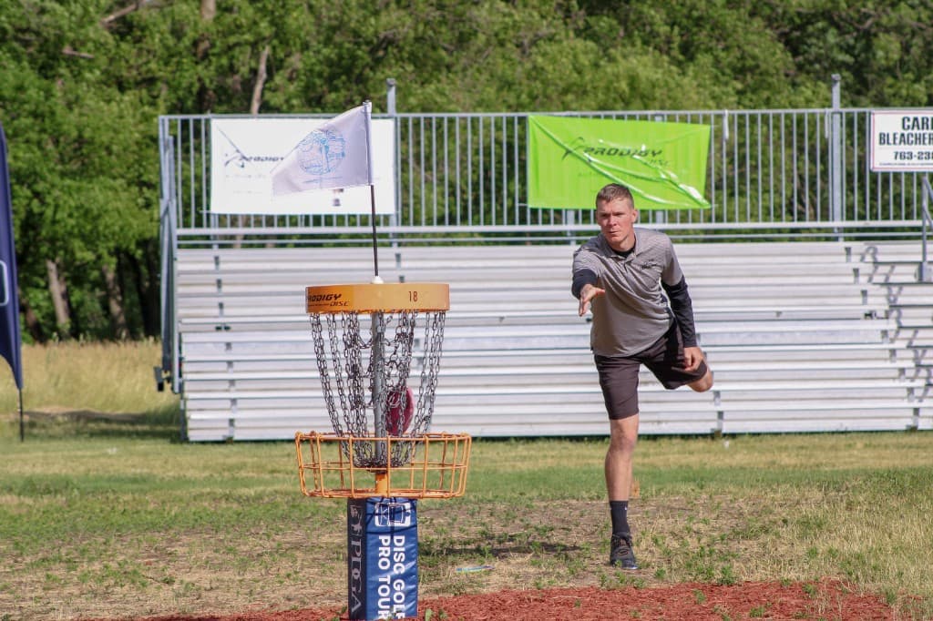 Competitive disc golf putt toward a basket